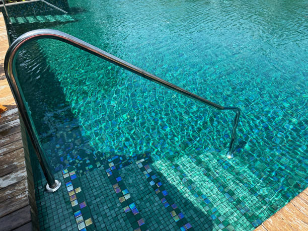 istock Metal rail and steps in outdoor swimming pool 1929968030