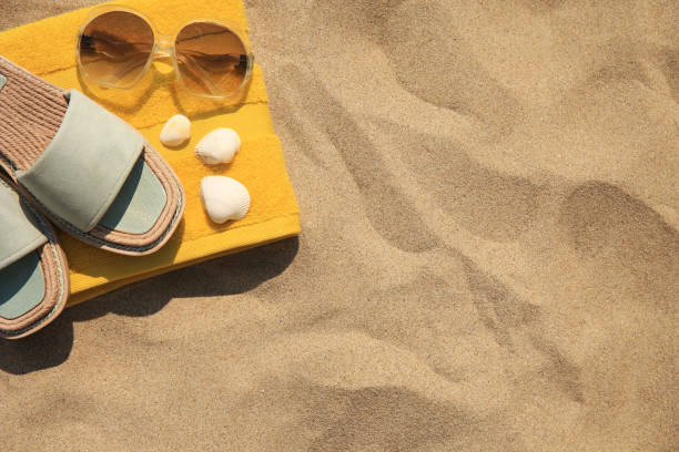 istock Beach accessories and seashells on sand, top view. Space for text 1929970911