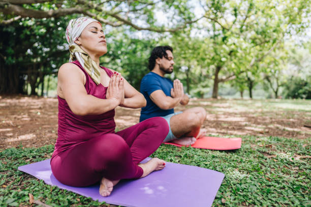 Couple doing yoga at park