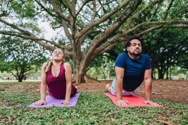 istock Couple stretching or doing yoga at park 1929974399