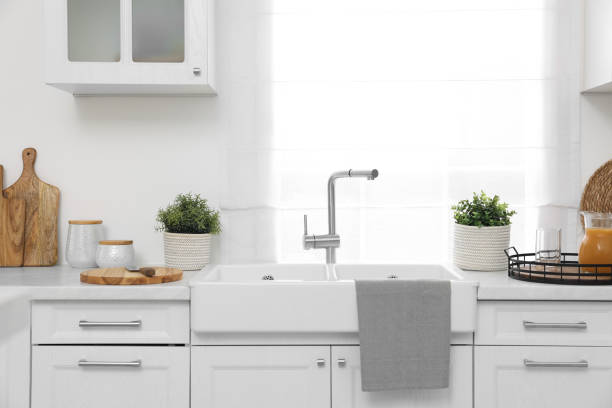 istock Different potted artificial plants on countertop in kitchen. Home decor 1929977056