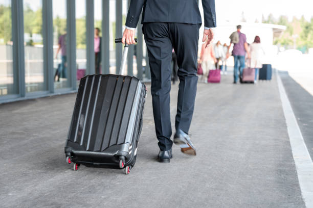 istock Businessman Dragging A Suitcase At The Airport 1929989429