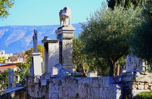 Ancient ruins in the cemetery of Keramikos. Old grave memorials, columns, statues