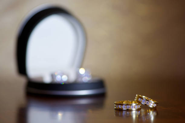 istock Wedding rings for weddings lie on a mirror reflecting surface. 1930003820