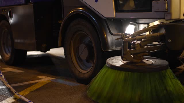 Street sweeper machine cleaning road.