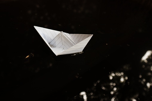 paper sailboat in the dark