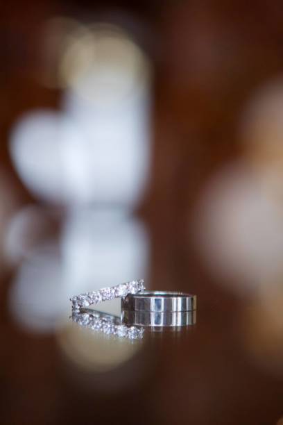 istock Wedding rings for weddings lie on a mirror reflecting surface. 1930019280
