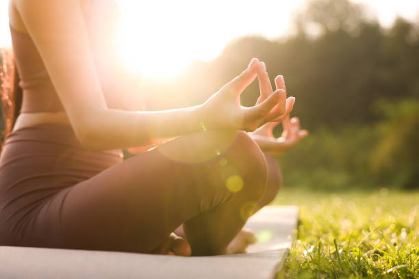 istock Woman practicing Padmasana on yoga mat outdoors, closeup. Lotus pose 1930020892