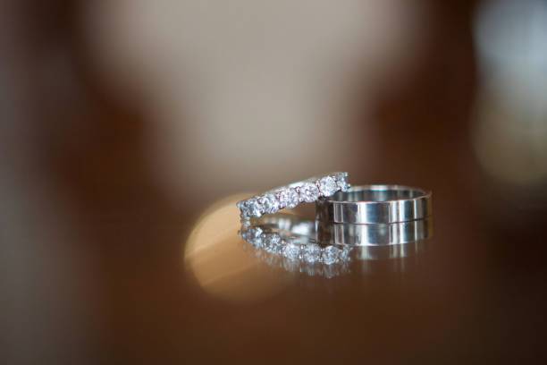 istock Wedding rings for weddings lie on a mirror reflecting surface. 1930023004