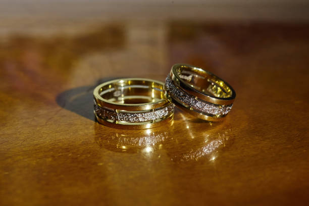 istock Wedding rings for weddings lie on a mirror reflecting surface. 1930024065