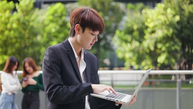 Business people using and working on laptop in city