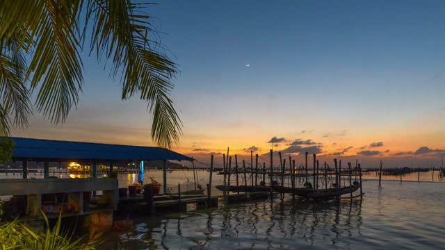 Time lapse of Sunset at fishing village in South of Thailand