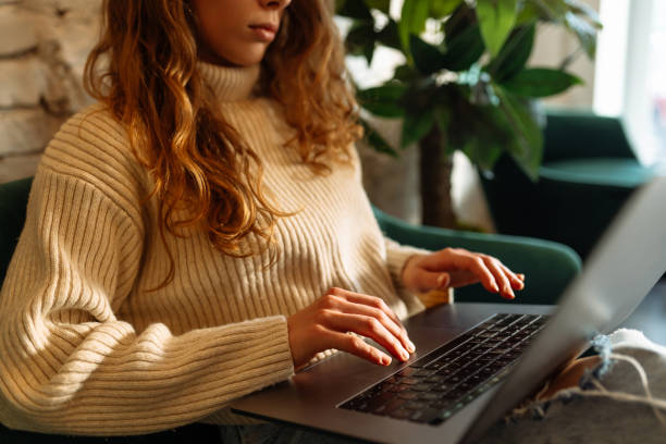 istock Close-up of hands working on a laptop keyboard. 1930040093