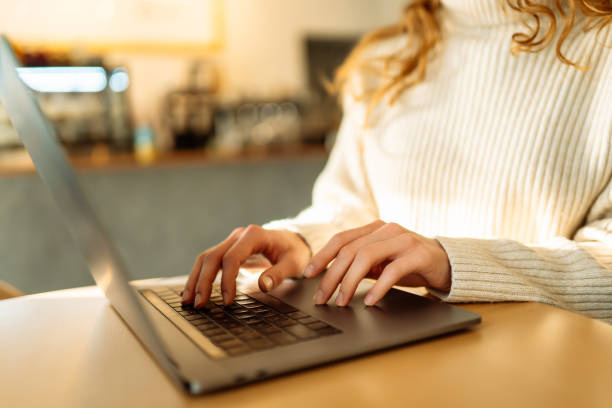 istock Close-up of hands working on a laptop keyboard. 1930040632