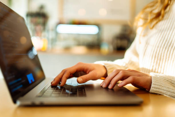 istock Close-up of hands working on a laptop keyboard. 1930040635