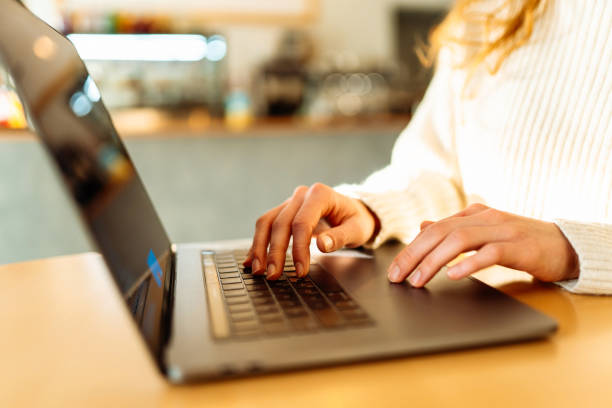 istock Close-up of hands working on a laptop keyboard. 1930040641