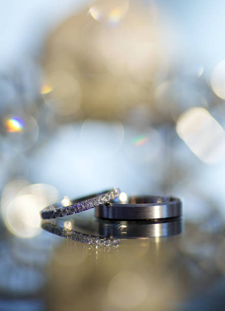 istock Wedding rings for weddings lie on a mirror reflecting surface. 1930053273