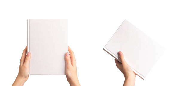 Book cover mockup in hand. Blank empty hardcover mock up set isolated on white