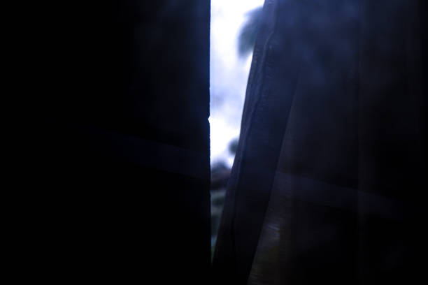 istock a little light behind the window pane 1930108450