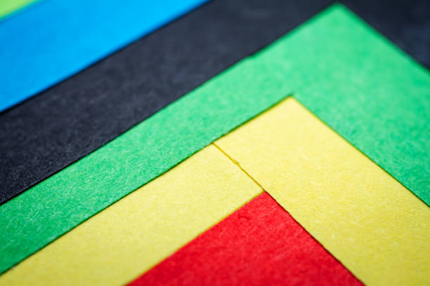 Small colorful blank sticky notes placed on a desk in an office.