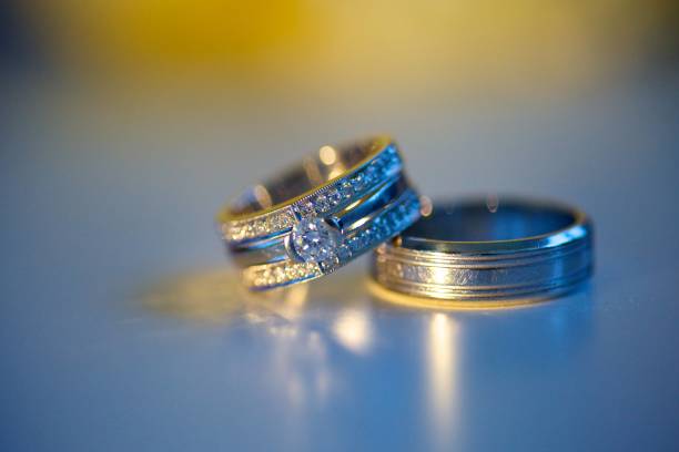 istock Wedding rings for weddings lie on a mirror reflecting surface. 1930117760
