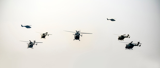 A group of helicopters are flying on isolated sky