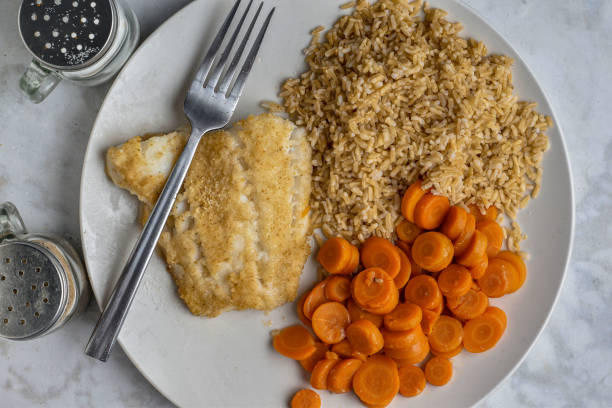 baked cod served with brown rice and carrots