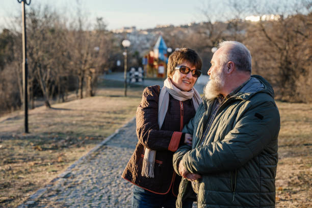 istock Happy senior couple hugging in the park 1930129246