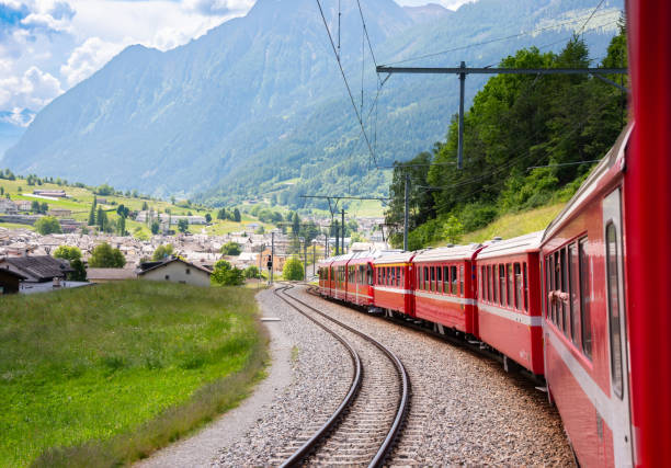 istock Red train moving in beautiful green summer forest in Switzerland 1930144824