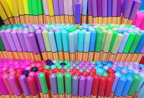 School supplies - color pencils on blue background
