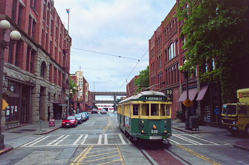 Seattle, Washington, USA - May 9, 1992:  Grainy archival film photograph of the S Jackson Street trolley on the 100 block of South Main Street.  The bridges in background have been demolished.