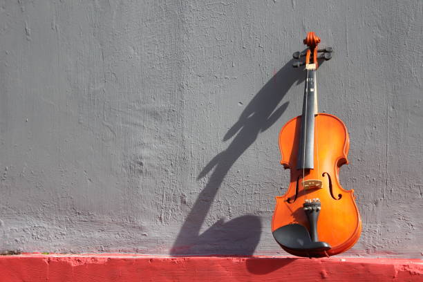 Old violin in the corner of the wall