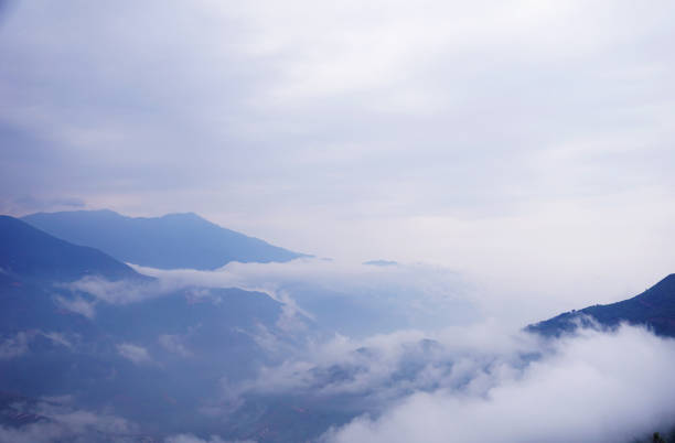 Clouds floating on Ta Xua mountain in Vietnam during morning hours