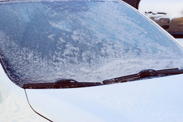 istock frozen car windshield with frozen wipers. close-up 1930291396