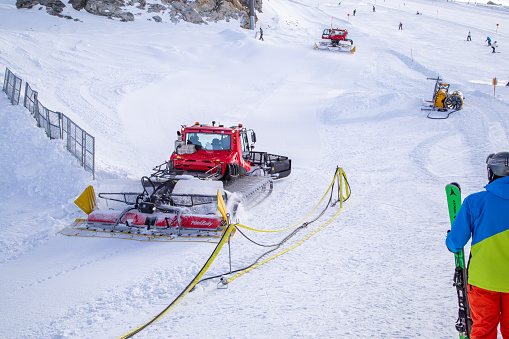Ratrac machine and Snow cannon on the glacier in Hintertux - Austria. Next to it is the ski slope. There is skiing on the Hintertux Glacier all year round, 365 days a year.