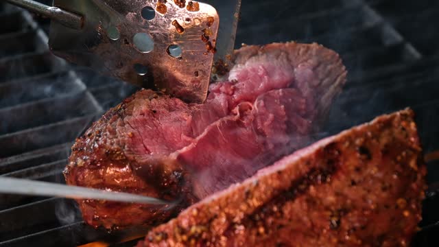 cut the meat over medium-rare fire beef medium Steak Cooking on Grill Slow Motion
