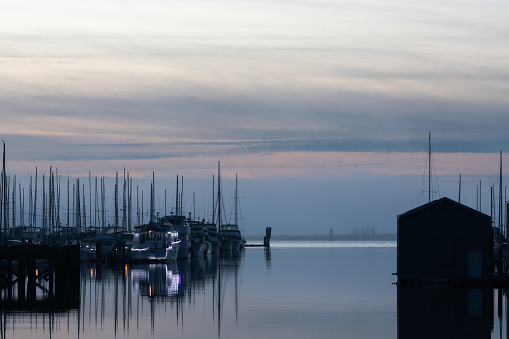 Boats in slips at the Everett WA Waterfront Harbor on a foggy winter evening