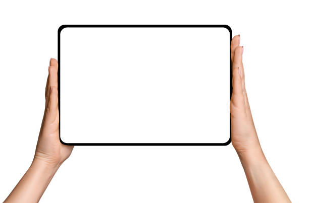 istock Female hands holding tablet with blank screen on empty background 1930369164