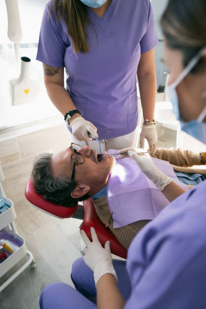 istock Man in a dentist cleaning his teeth 1930391118