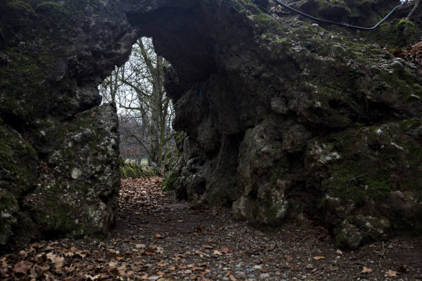 istock Passage under a rock formation in a park on a cloudy day in autumn 1930419209