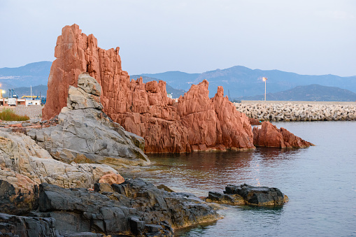 Geological feature called Rocce Rosse (red rocks) in Arbatax at the sunrise; east coast of Sardinia, Italy