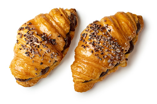Indulge in flaky perfection with two chocolate croissants. the crispy layers and rich cocoa filling create a delectable, gourmet treat. ideal for showcasing french pastry artistry, this image captures the essence of quality, indulgence, and a delightful breakfast or snack