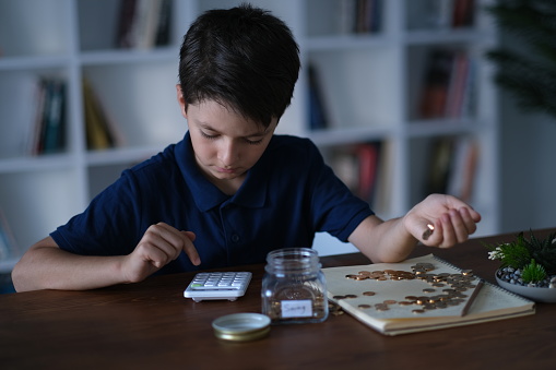 Little boy making small budget