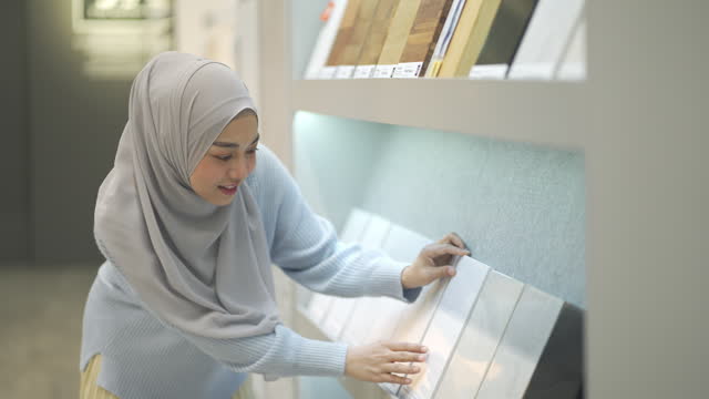 4K Young Muslim Woman Shopping Bathroom Tiles And Utensils In A Shopping Mall