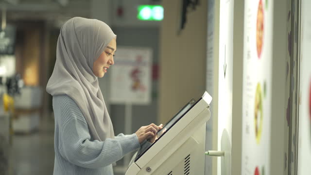 4K Young Muslim Woman Using Kiosk Touch Screen Display