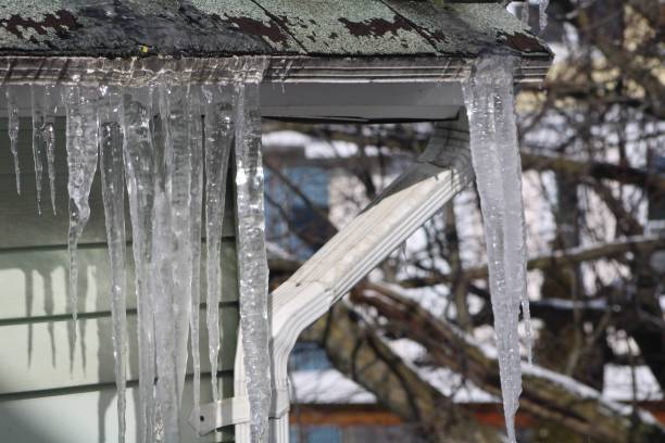 istock Icicles Hanging Off A Spouting On The Side Of A House. 1930552310