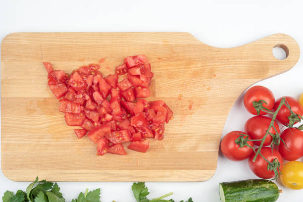 istock Top view of tomatoes cut into pieces for preparing a salad. 1930572522