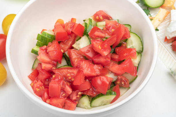 istock Bowl with chopped vegetables, tomatoes and cucumbers with peppers for preparing salad. 1930596686