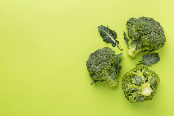 istock Flat lay with fresh broccoli on color background 1930645090