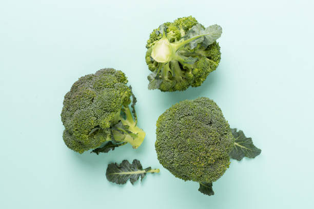 istock Flat lay with fresh broccoli on color background 1930645095